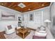 Cozy living room with a wooden ceiling, neutral furniture, and plenty of natural light at 173 Fishburne St, Charleston, SC 29403