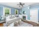 This main bedroom features a fireplace, ceiling fan, hardwood floors, and calming paint at 173 Fishburne St, Charleston, SC 29403