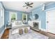 Main bedroom with a fireplace, large bed and lots of natural light at 173 Fishburne St, Charleston, SC 29403