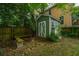 Backyard shed with brick base and green siding, offering extra storage; fire pit with benches at 173 Fishburne St, Charleston, SC 29403