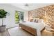 Bright bedroom showcasing stylish wallpaper, light colored walls, and a wicker bed frame at 1815 Long Bend Dr, Seabrook Island, SC 29455
