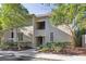 Multi-story condo building with a light exterior, surrounded by lush landscaping and mature trees at 1815 Long Bend Dr, Seabrook Island, SC 29455