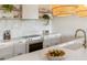 Bright kitchen features white quartz countertops, stainless steel appliances, and unique rattan pendant lights at 1815 Long Bend Dr, Seabrook Island, SC 29455