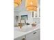 Stylish kitchen featuring brass faucet, white quartz countertops, and natural woven rattan pendant lights at 1815 Long Bend Dr, Seabrook Island, SC 29455
