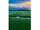 Scenic marsh view under a dramatic sky with green grass and a winding stream at 1815 Long Bend Dr, Seabrook Island, SC 29455
