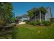 Backyard with screened in porch, pool, hot tub and patio furniture including chairs and umbrellas at 185 Red Leaf Blvd, Moncks Corner, SC 29461