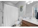 This bathroom includes a vanity, a toilet, a shower with a white shower curtain, and a big mirror at 185 Red Leaf Blvd, Moncks Corner, SC 29461
