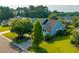 Charming blue two-story home with well-manicured lawn, mature trees, and a welcoming front entrance at 185 Red Leaf Blvd, Moncks Corner, SC 29461
