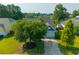 Inviting home exterior with a large tree, lush green lawn, and an attached two-car garage at 185 Red Leaf Blvd, Moncks Corner, SC 29461