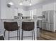 Modern kitchen with stainless steel appliances, white cabinets, and breakfast bar with stools at 185 Red Leaf Blvd, Moncks Corner, SC 29461