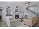 Cozy living room features a fireplace, ceiling fan, hardwood floors, and comfortable seating at 185 Red Leaf Blvd, Moncks Corner, SC 29461