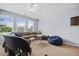 Large living room with neutral tones, a ceiling fan, a sectional couch, lots of natural light, and a blue beanbag at 185 Red Leaf Blvd, Moncks Corner, SC 29461