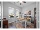 Bright home office with desk, large windows, and beautiful area rug at 185 Red Leaf Blvd, Moncks Corner, SC 29461