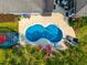 Aerial view of a private backyard pool surrounded by tropical landscaping and comfortable lounging areas at 185 Red Leaf Blvd, Moncks Corner, SC 29461