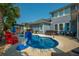 Backyard pool area, complete with comfortable seating, lounge chairs, a hot tub and ample space for relaxation at 185 Red Leaf Blvd, Moncks Corner, SC 29461