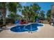 Backyard pool area, complete with comfortable seating, lounge chairs, a pergola swing and ample space for relaxation at 185 Red Leaf Blvd, Moncks Corner, SC 29461