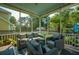 Screened in porch complete with comfortable seating including couches and chairs, offering a relaxing outdoor space at 185 Red Leaf Blvd, Moncks Corner, SC 29461