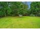 Expansive backyard with a storage shed and mature trees for a serene, private outdoor space at 2003 Savage Rd, Charleston, SC 29407