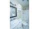 Bathroom with a framed mirror above a vanity with marble countertop and tiled shower stall at 2003 Savage Rd, Charleston, SC 29407