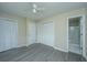 A well-lit bedroom features large closets, new flooring, and is attached to a bathroom at 2003 Savage Rd, Charleston, SC 29407