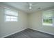 Cozy bedroom with hardwood floors, natural light from dual windows, and a ceiling fan at 2003 Savage Rd, Charleston, SC 29407