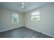 A bright bedroom features gray floors, fresh paint, and large windows creating a serene space at 2003 Savage Rd, Charleston, SC 29407