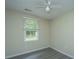Charming bedroom with hardwood floors, a ceiling fan, and a large window for natural light at 2003 Savage Rd, Charleston, SC 29407