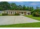 Charming single-story home featuring a spacious driveway, well-maintained lawn, and mature trees at 2003 Savage Rd, Charleston, SC 29407