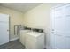Functional laundry room with modern washer and dryer and utility sink at 2003 Savage Rd, Charleston, SC 29407