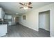 A spacious living room featuring modern gray floors and a ceiling fan with a light fixture at 2003 Savage Rd, Charleston, SC 29407