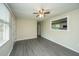 Open living room with stylish flooring, a ceiling fan, and a large window, creating an inviting atmosphere at 2003 Savage Rd, Charleston, SC 29407