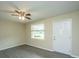Bright living room featuring modern flooring, neutral walls, a ceiling fan, and a window view to the front yard at 2003 Savage Rd, Charleston, SC 29407