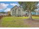 Green backyard featuring a large tree, fence, and patio at 202 Center Hill Ct, Summerville, SC 29485