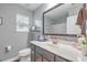 Well-lit bathroom with a modern vanity, toilet, and large mirror at 202 Center Hill Ct, Summerville, SC 29485