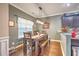 Sunlit dining room with a wooden table, bench seating, and stylish light fixture at 202 Center Hill Ct, Summerville, SC 29485