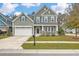 Charming two-story home with a welcoming front porch and well-manicured lawn and an attached two-car garage at 202 Center Hill Ct, Summerville, SC 29485