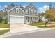 Well-maintained home featuring a covered front porch and a two-car garage with a white pergola detail over the entrance at 202 Center Hill Ct, Summerville, SC 29485