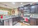 Well-lit kitchen featuring granite countertops, stainless steel appliances, and rich wood cabinetry at 202 Center Hill Ct, Summerville, SC 29485