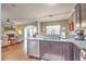 Open-concept kitchen with stainless steel appliances, dark cabinets, and a view into the adjacent living room area at 202 Center Hill Ct, Summerville, SC 29485