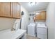 Functional laundry room featuring modern appliances, storage cabinets, and a folding area at 202 Center Hill Ct, Summerville, SC 29485