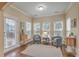 Bright sunroom with lots of windows, neutral paint, and hardwood floors at 202 Center Hill Ct, Summerville, SC 29485