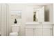 Clean bathroom with white cabinets, a framed mirror, and neutral decor; simple and functional at 211 Agrarian Ave, Summerville, SC 29485