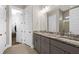 Modern bathroom with granite countertops, dual sinks, tile flooring, and a view into the walk-in closet at 2208 Primus Rd, Mount Pleasant, SC 29466
