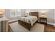 Serene bedroom featuring a wooden bed frame, cozy textiles, and soft lighting for a restful ambiance at 2208 Primus Rd, Mount Pleasant, SC 29466