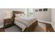 Cozy bedroom with wood-frame bed, neutral bedding, and natural light from the shuttered window at 2208 Primus Rd, Mount Pleasant, SC 29466