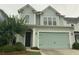 Charming two-story home with light-blue siding, a two-car garage, and a well-manicured front yard at 2208 Primus Rd, Mount Pleasant, SC 29466