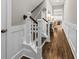 Hallway featuring staircase with decorative wood trim and hardwood floors at 2208 Primus Rd, Mount Pleasant, SC 29466
