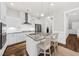 Modern white kitchen featuring stainless steel appliances, granite countertops, and a stylish kitchen island at 2208 Primus Rd, Mount Pleasant, SC 29466