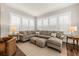 Elegant living room with a plush sectional, neutral tones, and plenty of natural light from large windows at 2208 Primus Rd, Mount Pleasant, SC 29466