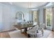 Dining room with a wooden table, upholstered chairs, elegant chandelier, and natural light at 2225 Black Oak Ct, Mount Pleasant, SC 29466
